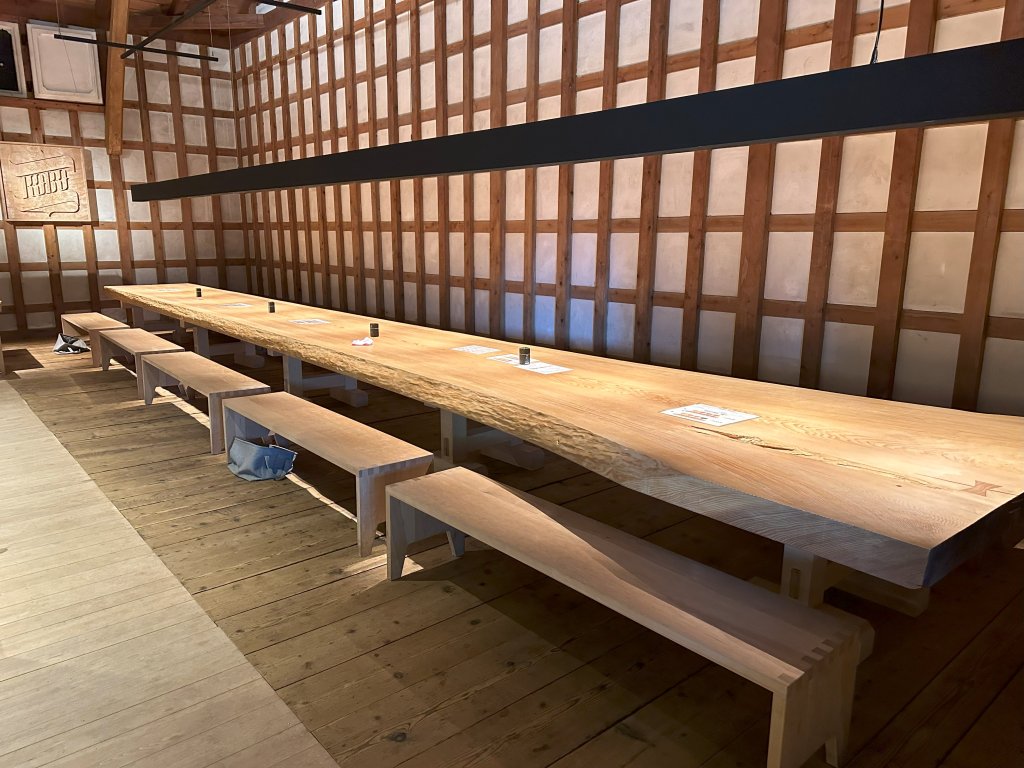 massive long table with the top slabbed from a single tree trunk (inside Kobo)